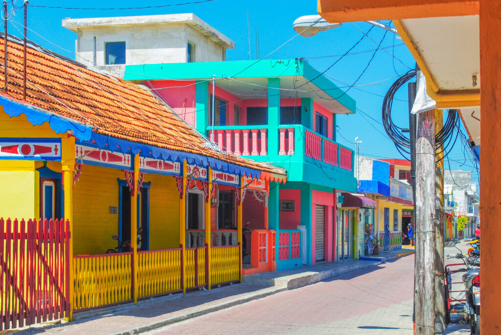 Isla Mujeres colorful city architecture. an island Caribbean Sea. tourism attractions around Cancun. Bright yellow and blue turqoise mexican latin america traditional houses.